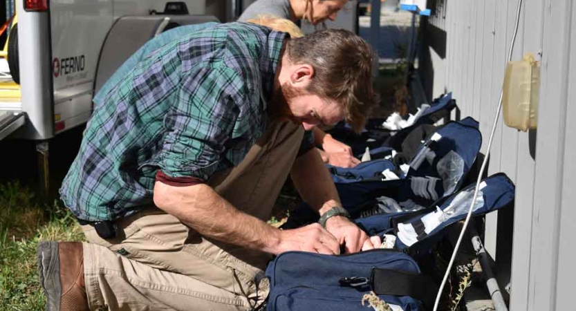 Outward bound students appear to pack medical bags during a service project